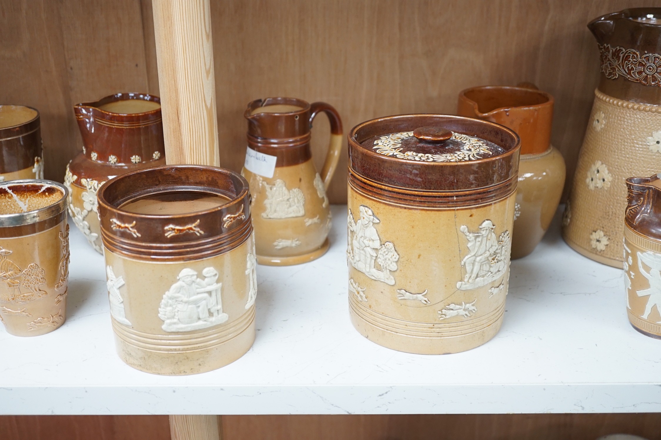 A group of Doulton stoneware jugs, storage jar, beakers, bowls etc